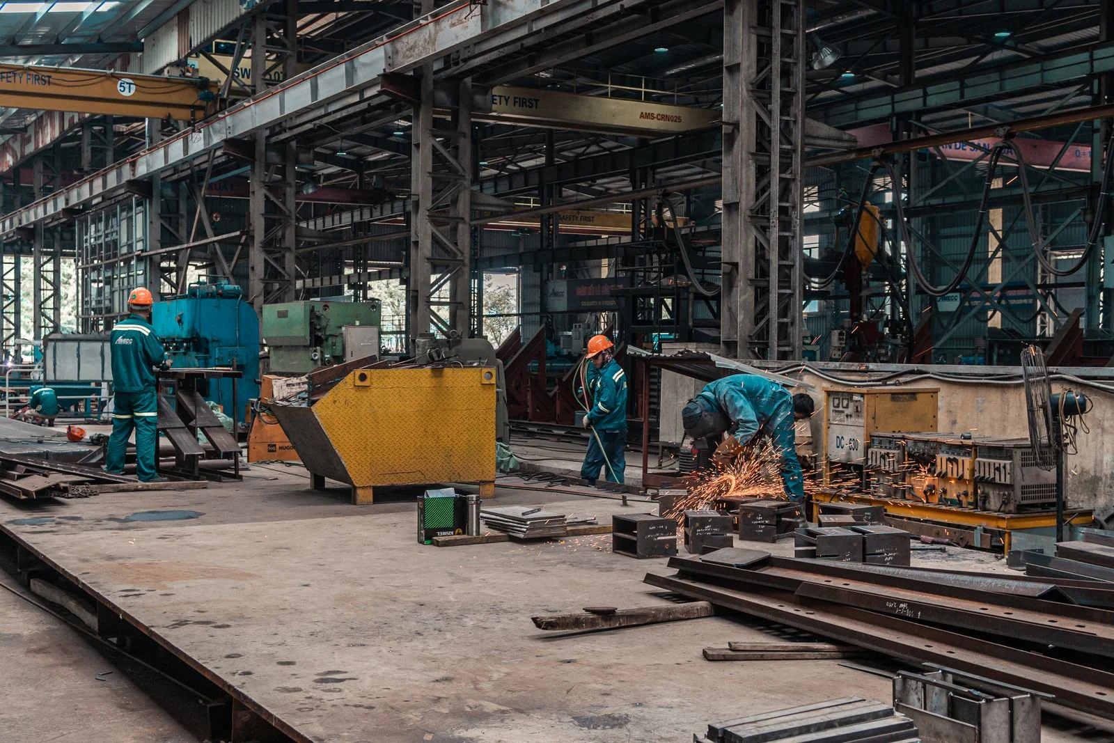 Metalworkers at work in an industrial workshop