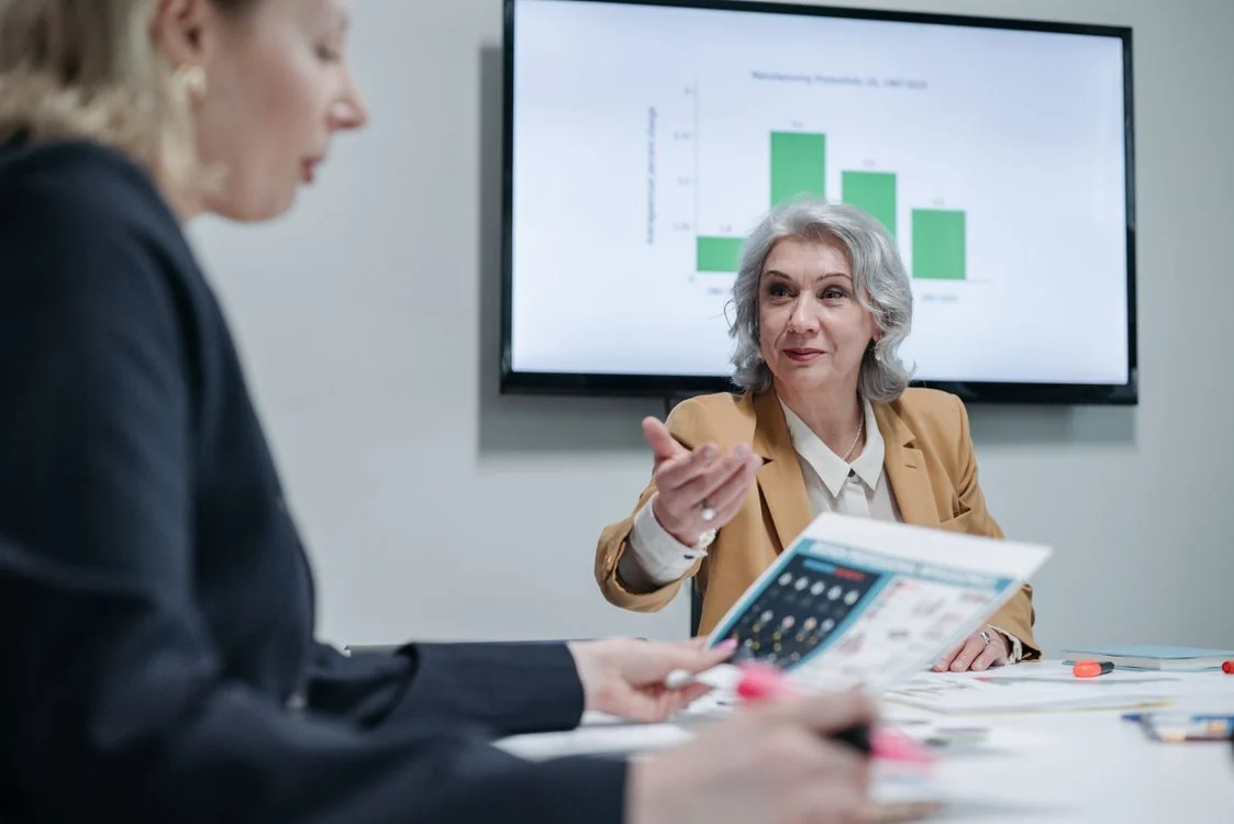 Two business professionals discussing information in an office