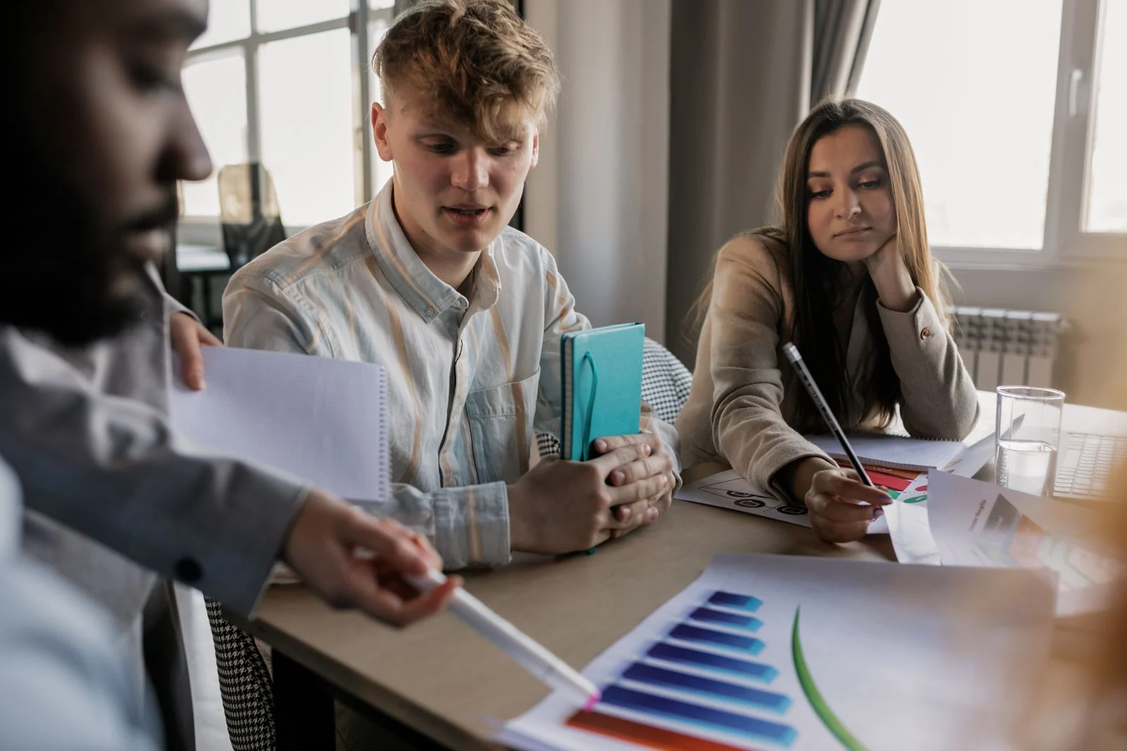 Professionals reviewing printed charts and documents