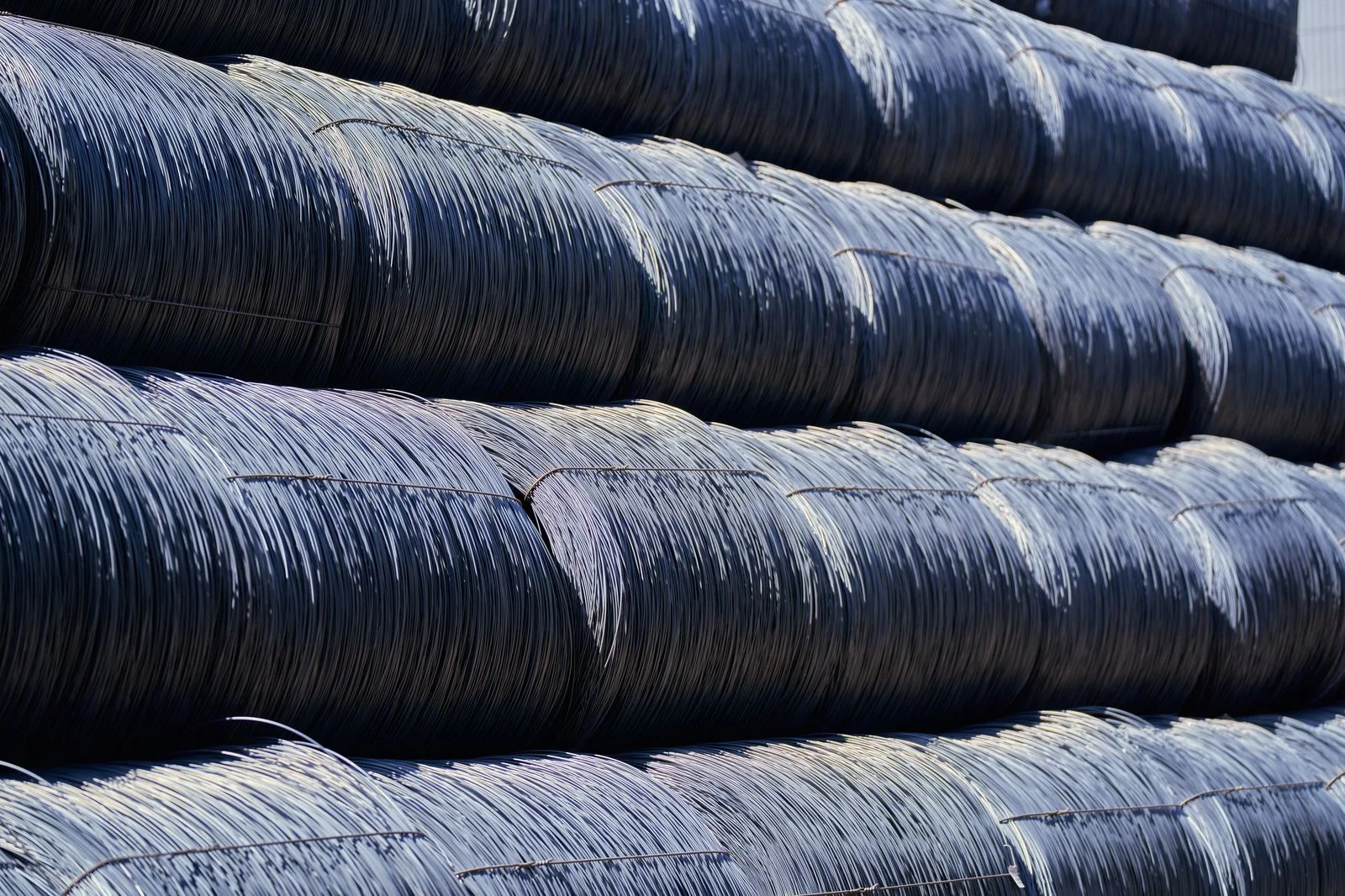 Steel wire coils stacked in curved bundles